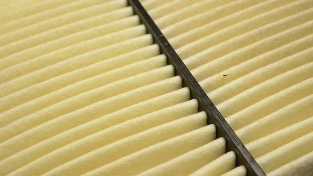 HEPA air filter to stop spread of dust particles floating in the air, dust grains with air pollution and prevent allergy. Macro slow motion view. High efficiency particulate air filter macro close up