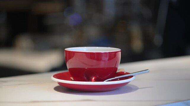 A cup of coffee in a cozy cafe with steam appearing