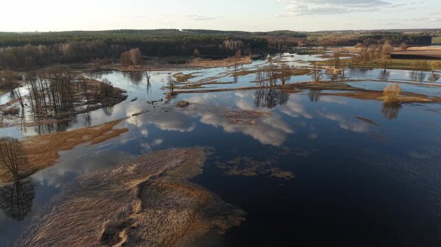 Golden Hour Backward Descend Over Reflective Floodplain