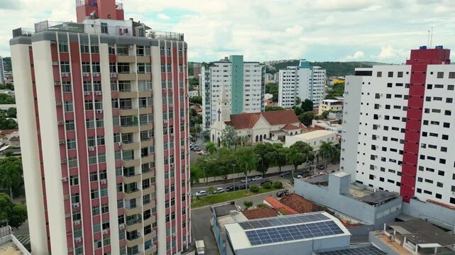 Aerial drone flyover of the city of Governador Valadares, Minas Gerais, Brazil, located along the banks of the Doce river. The footage captures the cityscape, surrounding riverfront, and key landmarks