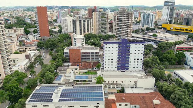 Aerial drone flyover of the city of Governador Valadares, Minas Gerais, Brazil, located along the banks of the Doce river. The footage captures the cityscape, surrounding riverfront, and key landmarks