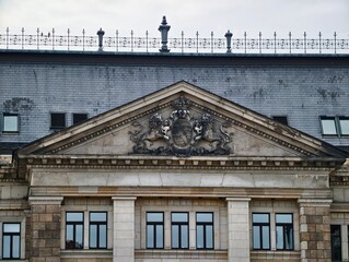 Architectural relic displaying engraved heraldic shield with weathered masonry and ornate inscriptions © Vladimir
