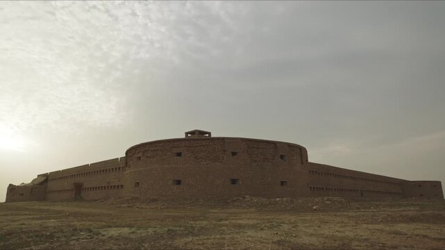 Panoramic view of the massive Derawar Fort against a hazy sky in the Cholistan Desert, Pakistan