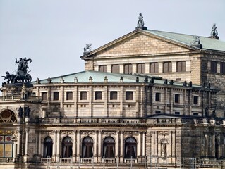 Fototapeta premium Elegant historic facade. Stylish neoclassical building showcasing sculptures and decorative elements