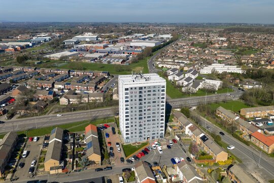 Aerial view of the town of Seacroft in Leeds West Yorkshire UK showing a tower block housing estates roads and parked cars with surrounding neighbourhood and streets in the spring time
