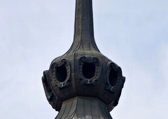 Detailed view of elaborate copper turret with round openings and charming historic features © Vladimir