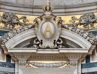 Majestic royal symbol gracing ornate historic palace entrance illuminated by natural sunlight © Vladimir