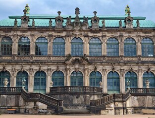 Detailed ornate facade of classical palace featuring sculptural balustrades and verdigris roofline © Vladimir
