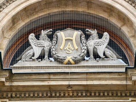 Decorative limestone emblem. Detailed limestone facade featuring griffins and emblems for restoration themes
