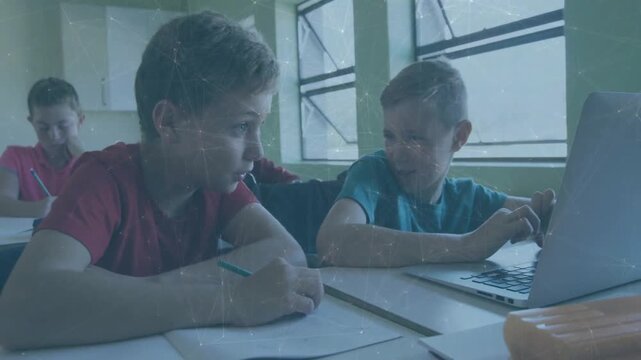 Boy in blue leaning, tapping laptop, showing notes and urging redshirt to collaborate in education