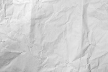 Fototapeta premium High resolution background texture of crumpled white paper. Detailed view of creases and wrinkles on a neutral surface, perfect for overlays, stationery design, and abstract creative projects.