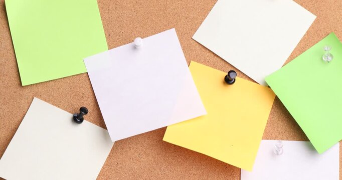 Reminder. Woman putting sticky note onto cork board, closeup