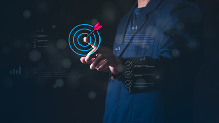 Concept of achievement, success, performance tracking, data analysis, and hitting the corporate objective, Businessman pointing at the target bullseye for business goals and marketing strategy. © 418 House
