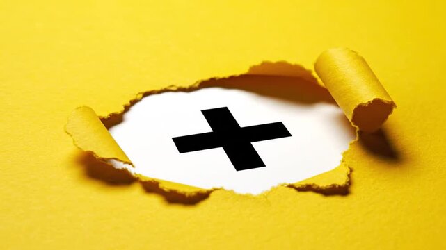 A torn yellow paper reveals a white background with a black cross symbol.