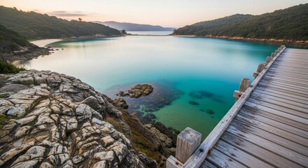 Obraz premium Coastal landscape, turquoise water and scenic bay during sunset for nature photography, tranquil environment and peaceful getaway with wooden pier extending into ocean view. Serenity, relaxation and