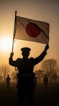 Japanese Self-Defense Forces soldier holding national flag at dawn during a patriotic honor ceremony