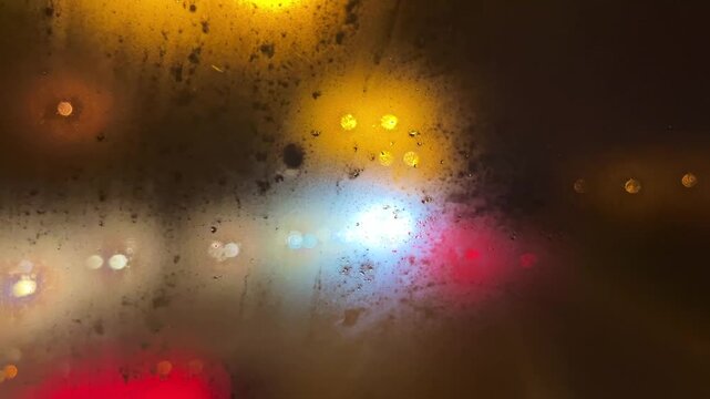 View from a fogged car window at rainy night in Istanbul, Turkey. (4K video)