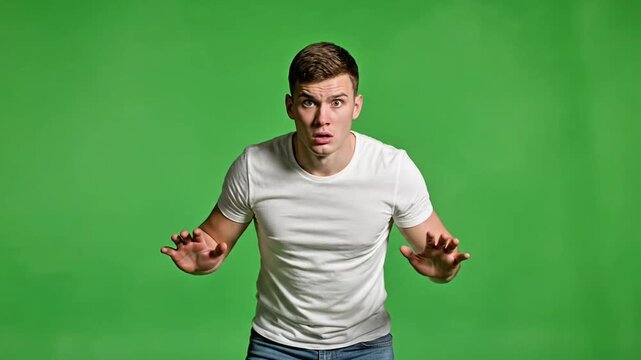 Man stepping back fear cautious gesture green background