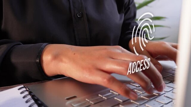 Focus on a businesswoman's hands on her laptop with a fingerprint animation and the word "Access". Biometric access.