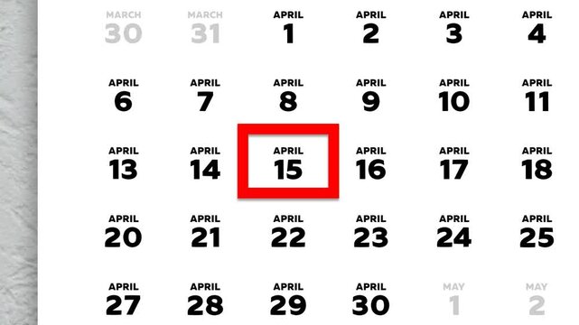 The date April 15th marked with a red cursor on the wall calendar 2026