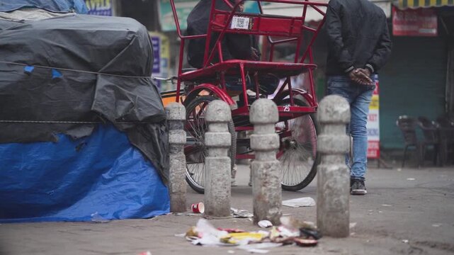 Cycle rickshaw on busy Indian street, Urban roadside scene with rickshaw and pedestrian, Daily life street view with cycle cart India, City transport and street activity India stock video.