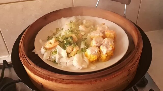 Opening the bamboo steamer lid to reveal a plate of steaming dim sum for breakfast.