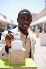 Entrepreneur presenting a product at a summer expo booth for World Entrepreneurs Day