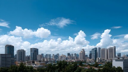 Fototapeta premium A vibrant city skyline under a bright blue sky with fluffy white clouds showcasing modern architecture