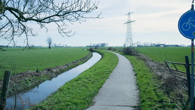 First-person perspective following a bicycle lane through a dutch polder landscape