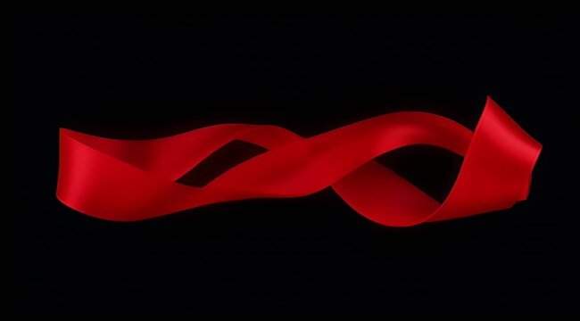 Elegant red satin ribbon flowing in a smooth sinuous shape on black background