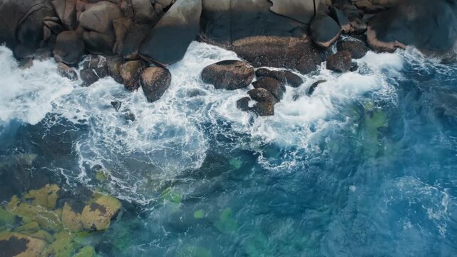 Aerial View of Waves Crashing on Rocky Coastline in Tayrona Park, Colo
