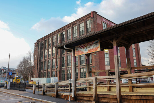 Waltham commuter rail station platform and historic mill building in Massachusetts