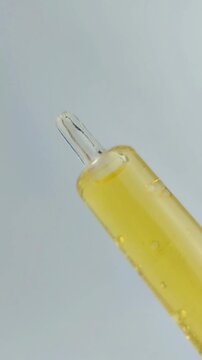 Close up process of opening and reassembling an anti acne serum product. Skincare routine, precise handling of dropper bottle, cosmetic packaging detail on clean background.