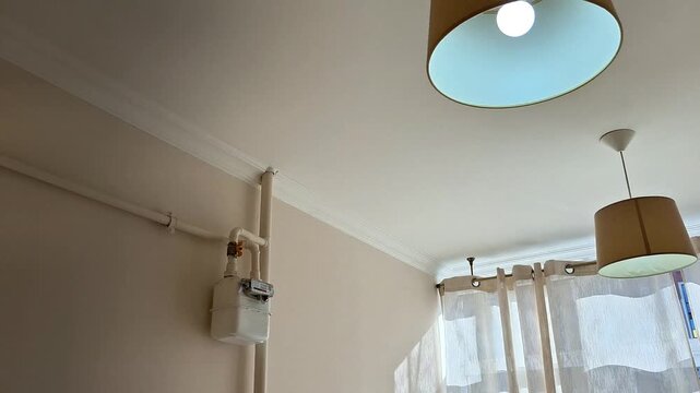 Soft morning glow as sunlight filters through sheer curtains, ceiling lamp casting gentle light, creating a calm and peaceful atmosphere in a simple room corner