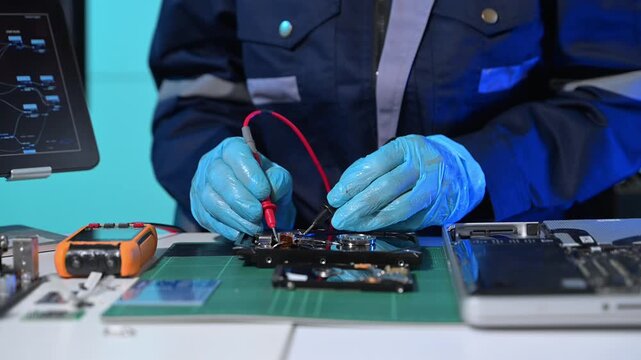 Technician repairing inside of hard disk drive by screwdriver. the concept of data, hardware, technician and technology. computer hardware, repairing, upgrade