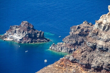 Fototapeta premium Rocky coastline and small chapel in Santorini Greece