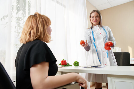Young girl visiting nutritionist to lose weight with the help of diet program