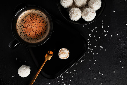 Coconut candies with nuts on dark background. Raffaello on black background. High quality photo