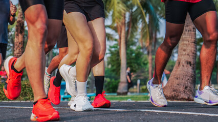 Fototapeta premium Group running session in park environment showing active people training together for health endurance and outdoor fitness lifestyle