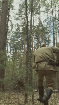 Reenactor Dressed As Russian Soviet Infantry Soldier Of World War Ii Run With Rifle Mosin Nagant. War Combat In Forest. Reenactment Tactic Game. Red Soviet Army Military Uniform