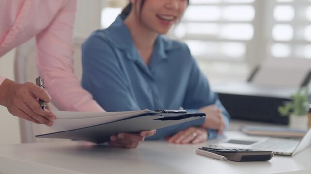 Adult Asian woman hand hold pen point laptop screen desk office business concept productivity planning remote work strategy professional workplace