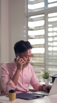 Adult Asian man work laptop home office freelance remote online business professional computer screen focus productivity technology startup digital nomad