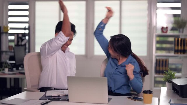 Asian adult business professionals discuss work project reviewing data on laptop computer at modern office workplace manager instructing employee guidance problem solving
