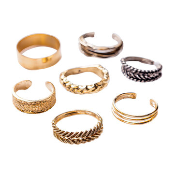 Assortment of toe rings with varying designs, displayed on a black background