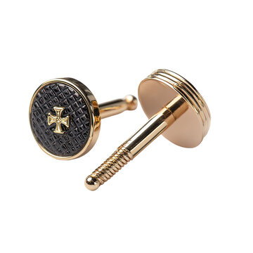 Close-up of gold cufflinks with black textured details and a prominent cross design