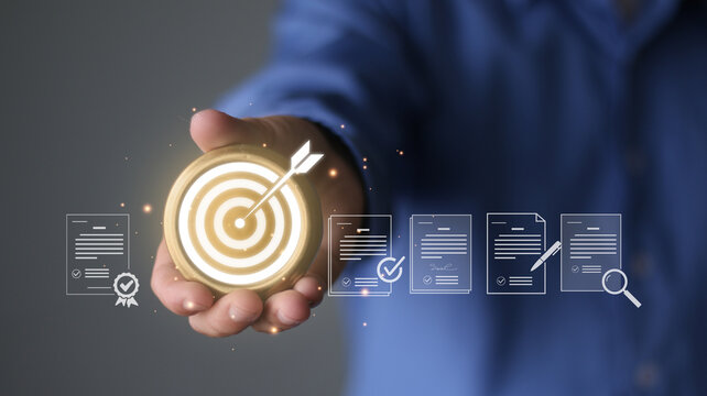 Auditing, compliance, quality control and legal standard achievement for professional strategy. Success business goal concept. Hand holding gold target with arrow, document icons