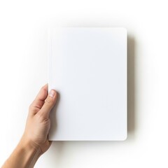 Obraz premium A hand holding an open blank white notebook against a plain background