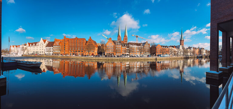 Panoramic Lubeck Old Town waterfront reflected in Trave River