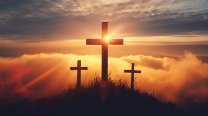 Fototapeta premium Three crosses on hill at sunset with clouds
