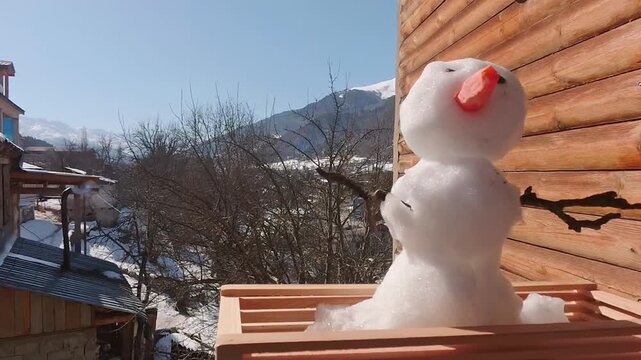 Timelapse melting snowman in high mountains - poignant symbol of global warming, rising alpine temperatures, and the accelerating loss of seasonal snowpack.End of ski season, end of winter concept
